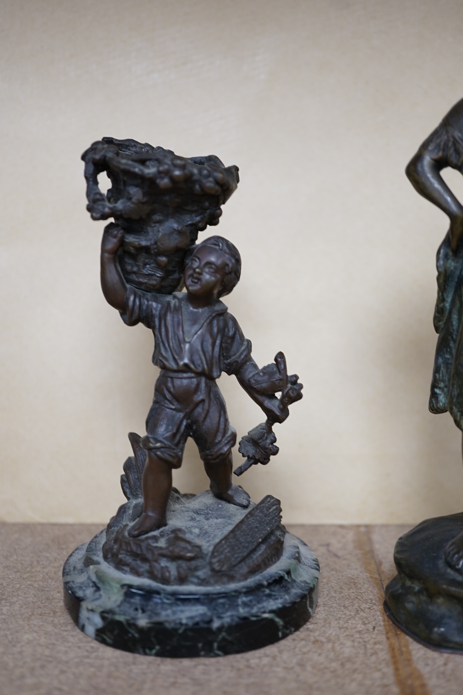 A bronze study of a girl holding a tambourine, and a bronze boy carrying grapes, raised on marble base, largest 16cm high. Condition - good